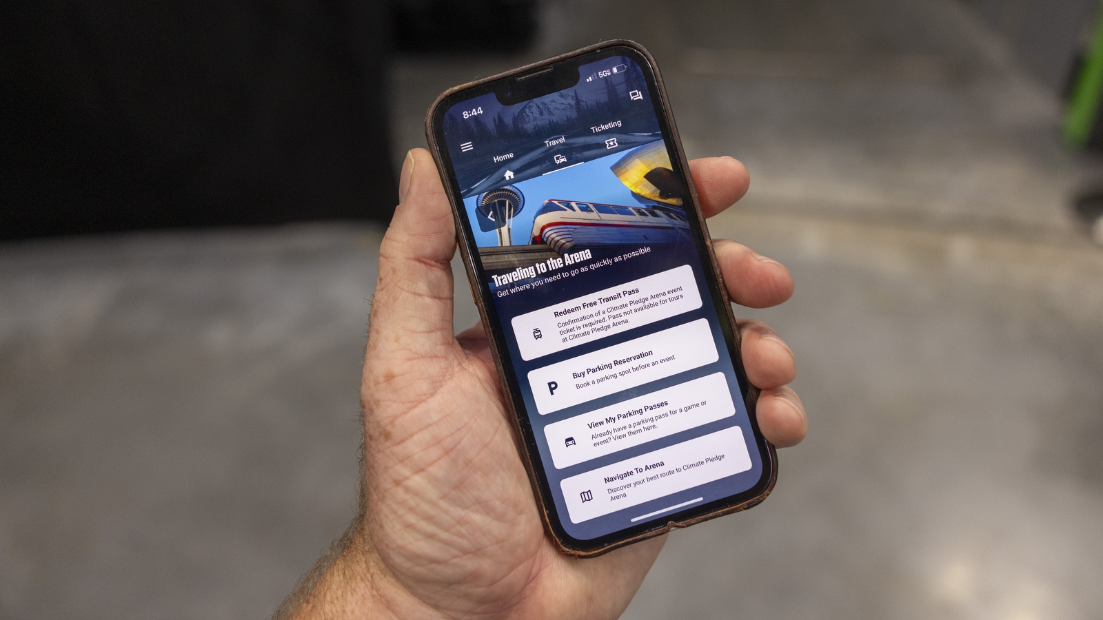 An image of the Seattle Kraken app. There is an image of the monorail along with buttons to select the mode of transportation you plan to take to the arena.