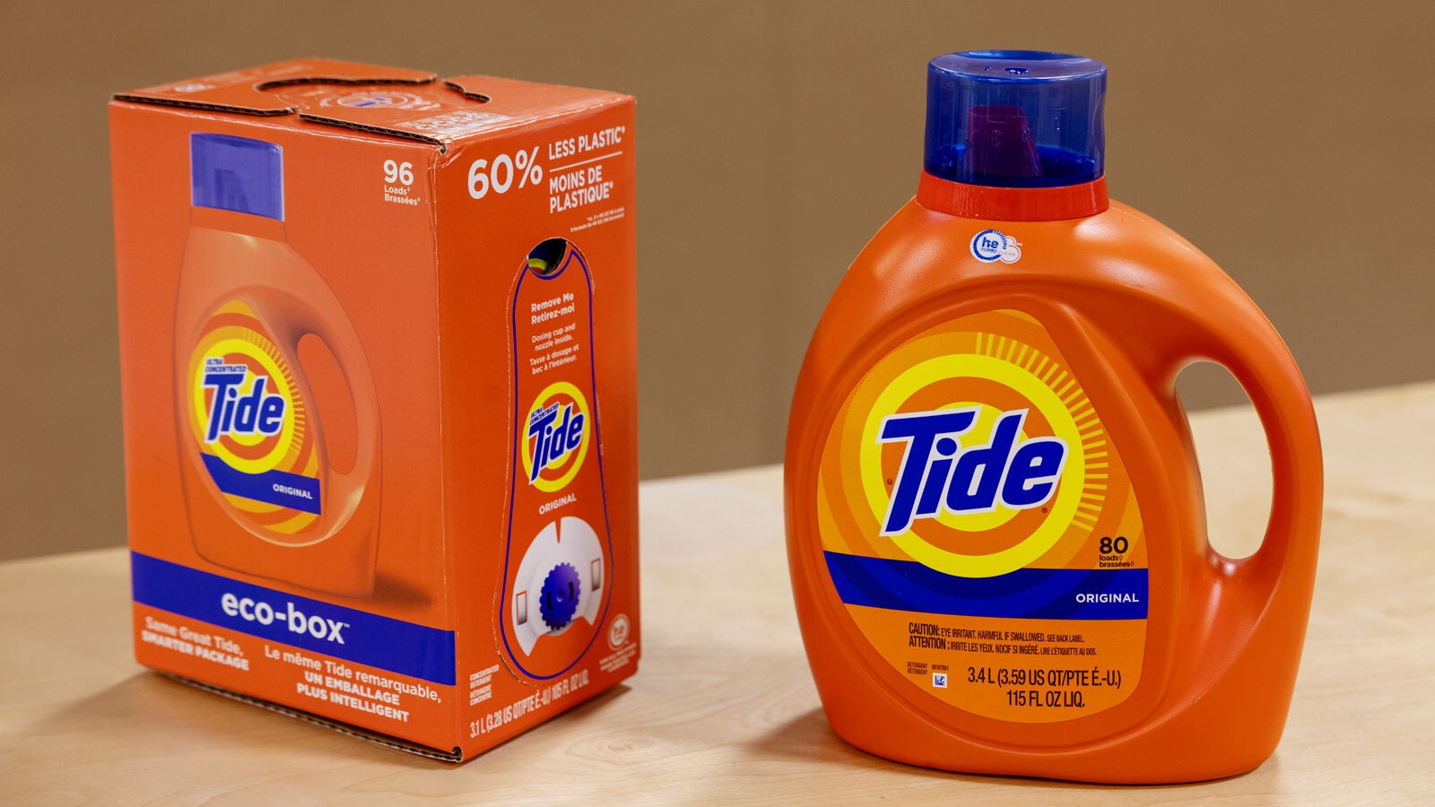 An image of two packages of Tide clothing detergent. One is a box with a spout on it and the other is a plastic bottle.