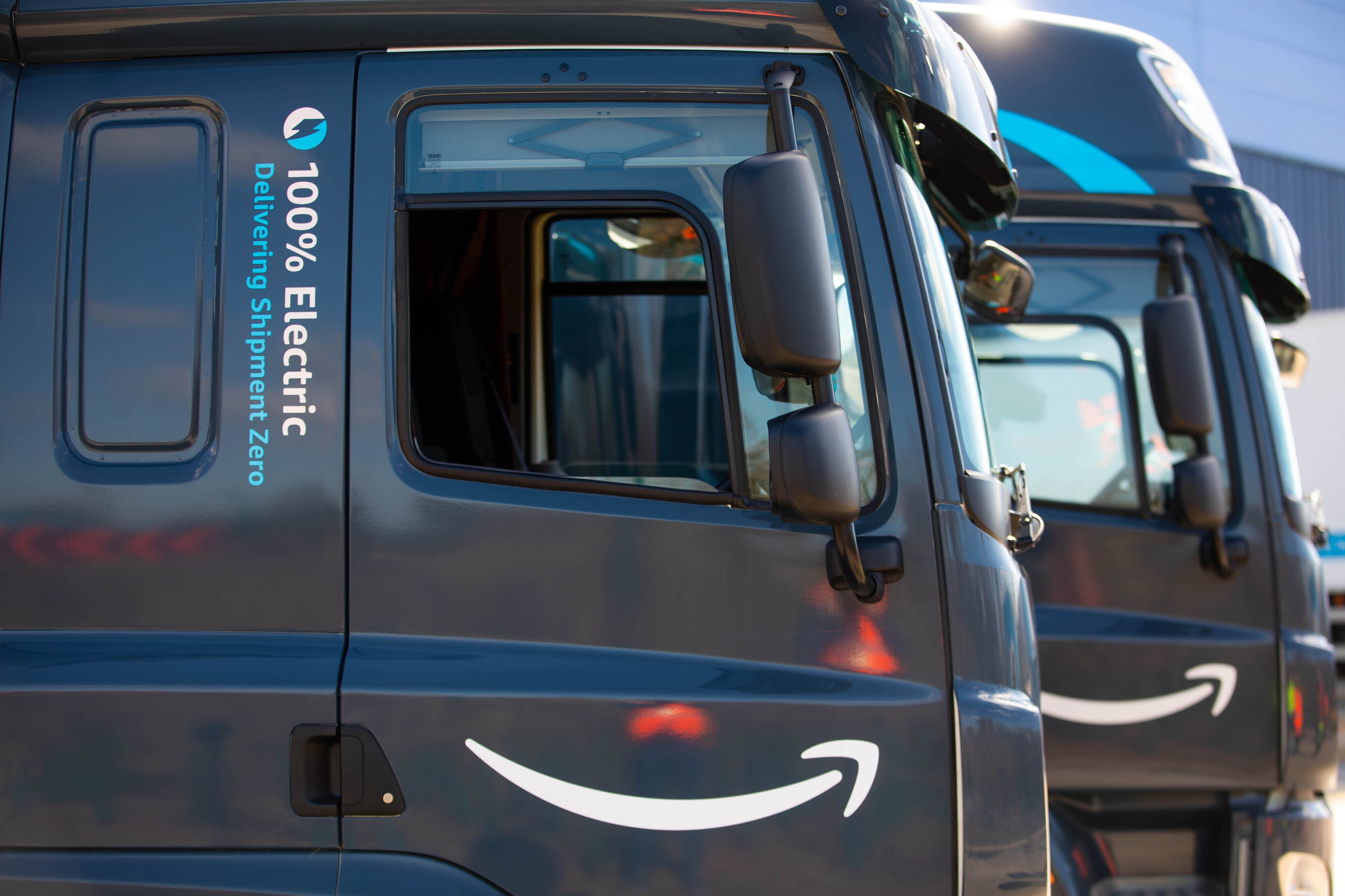 An image of two Amazon electric vans. 