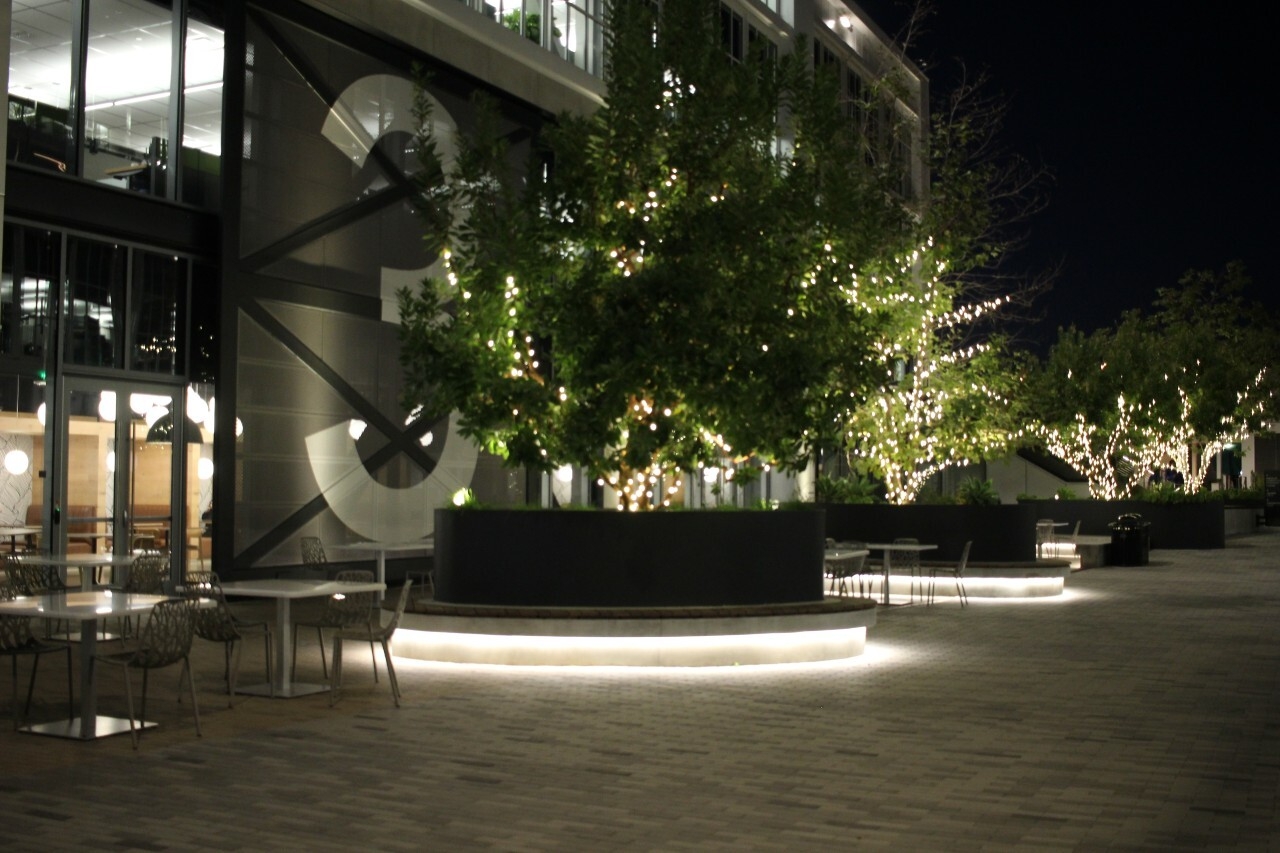 An image of the outside of the Amazon Studios offices at night. Lights illuminate the steps and pathways.