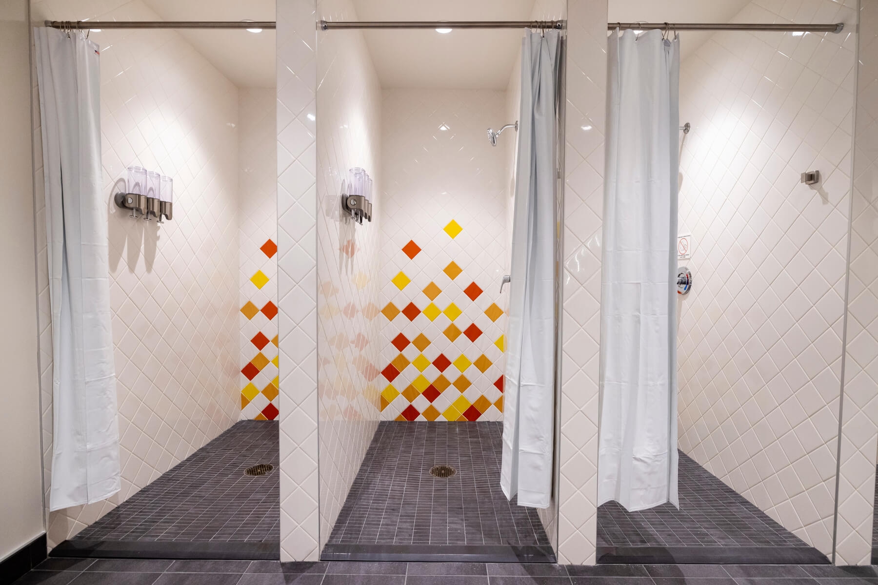 An image of empty shower stalls inside the empty locker room at Amazon's HQ2