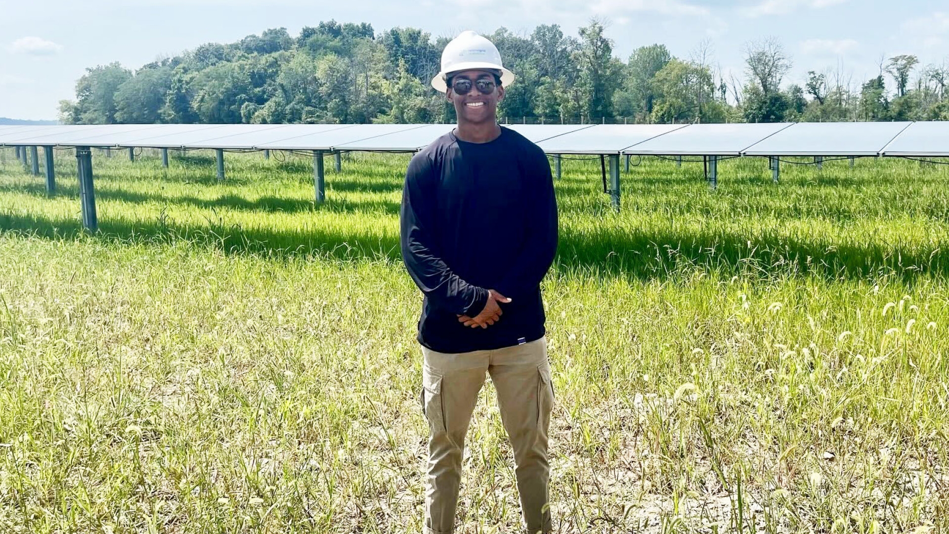 Image of Zegale Talmadge standing in a solar field in Ohio.