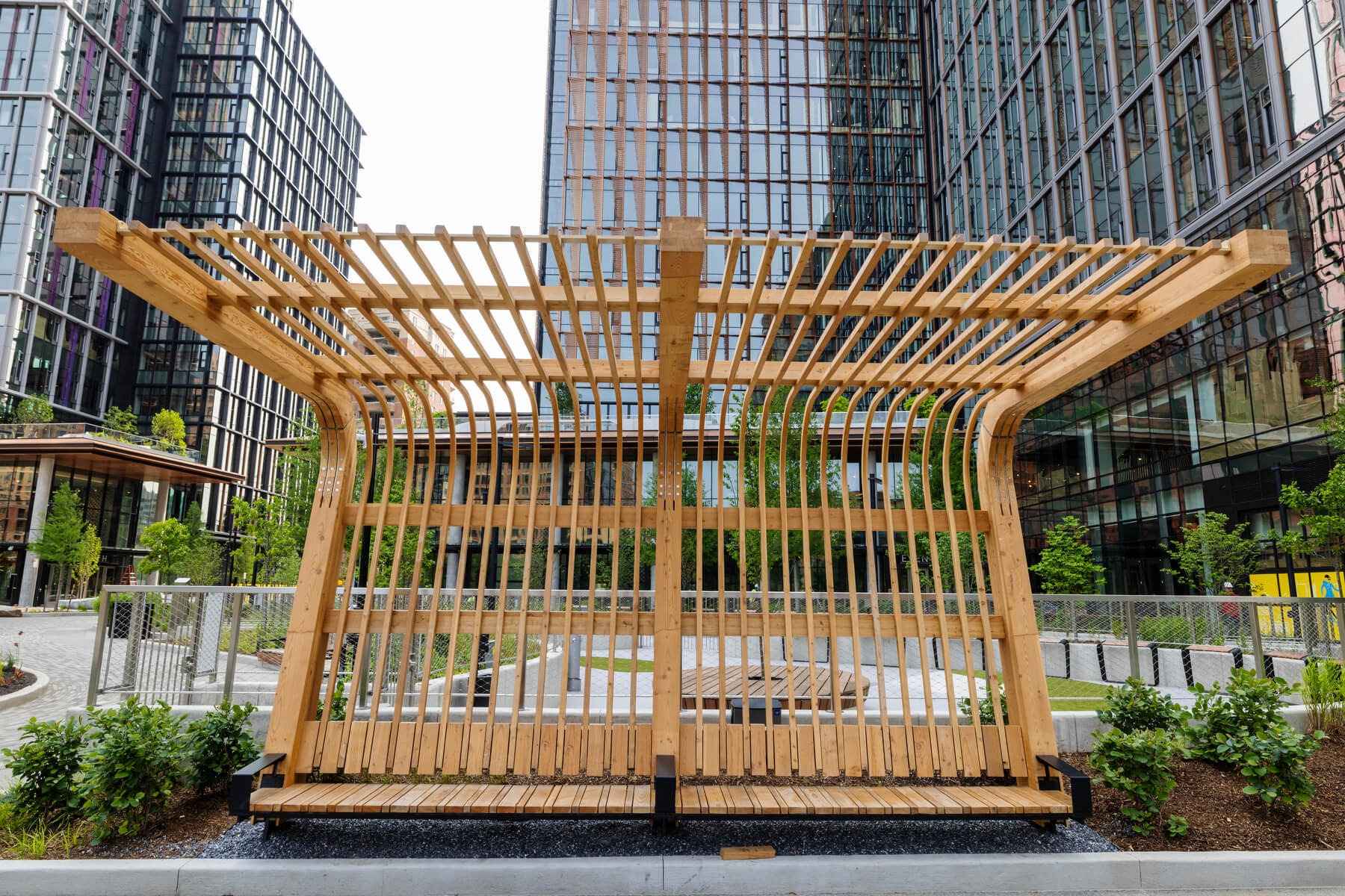 An image of a bus stop with an elaborate wooden covering and backdrop outside Amazon's second headquarters in arlington virginia