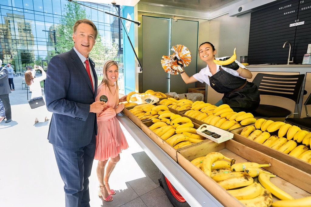 An image of Governor Glenn Youngkin of Arlingon, VA at Amazon's second headquarters. He is getting a free banana at the banana stand.
