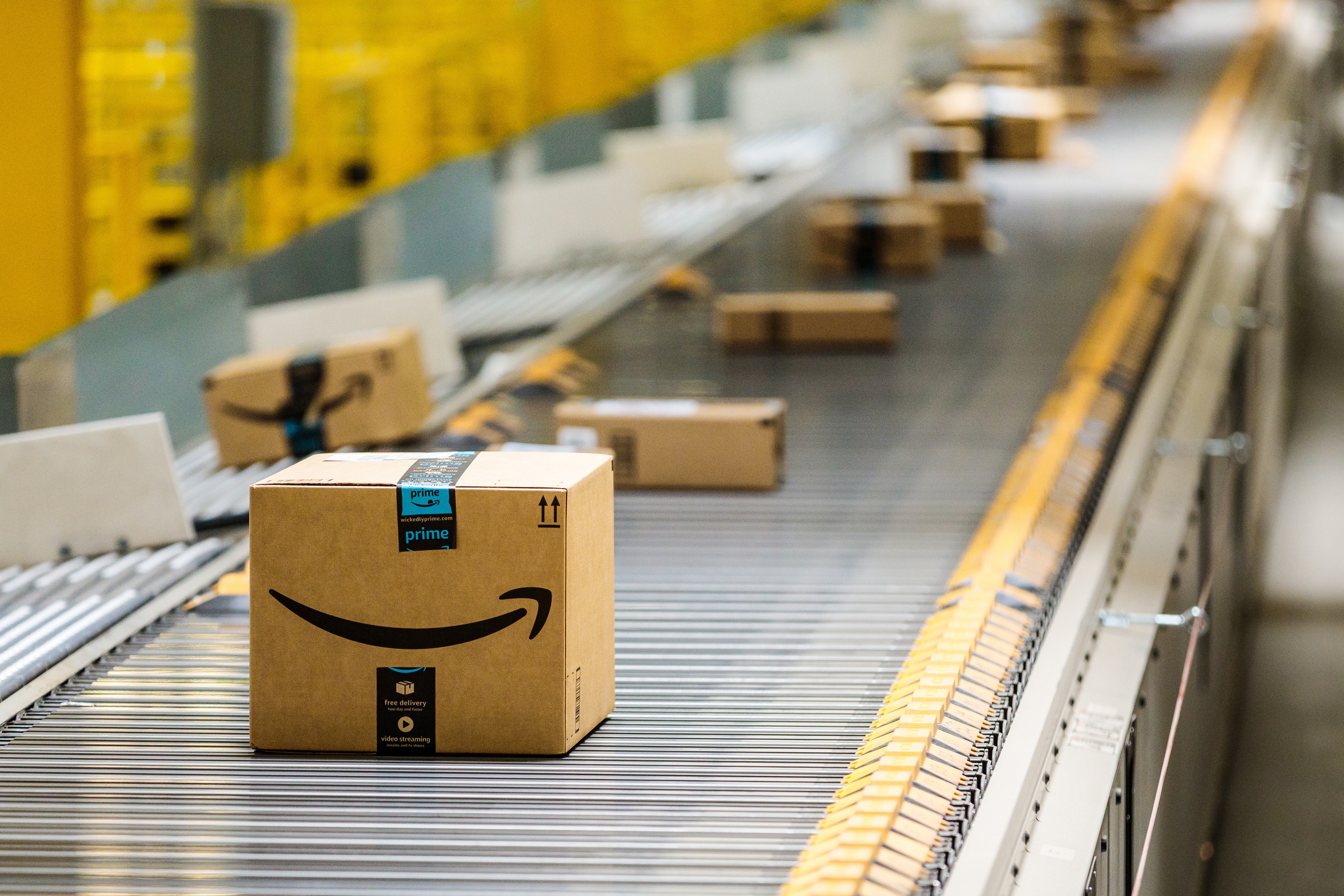 Amazon delivery boxes roll down a conveyor belt at Amazon's warehouse in Baltimore, Maryland.