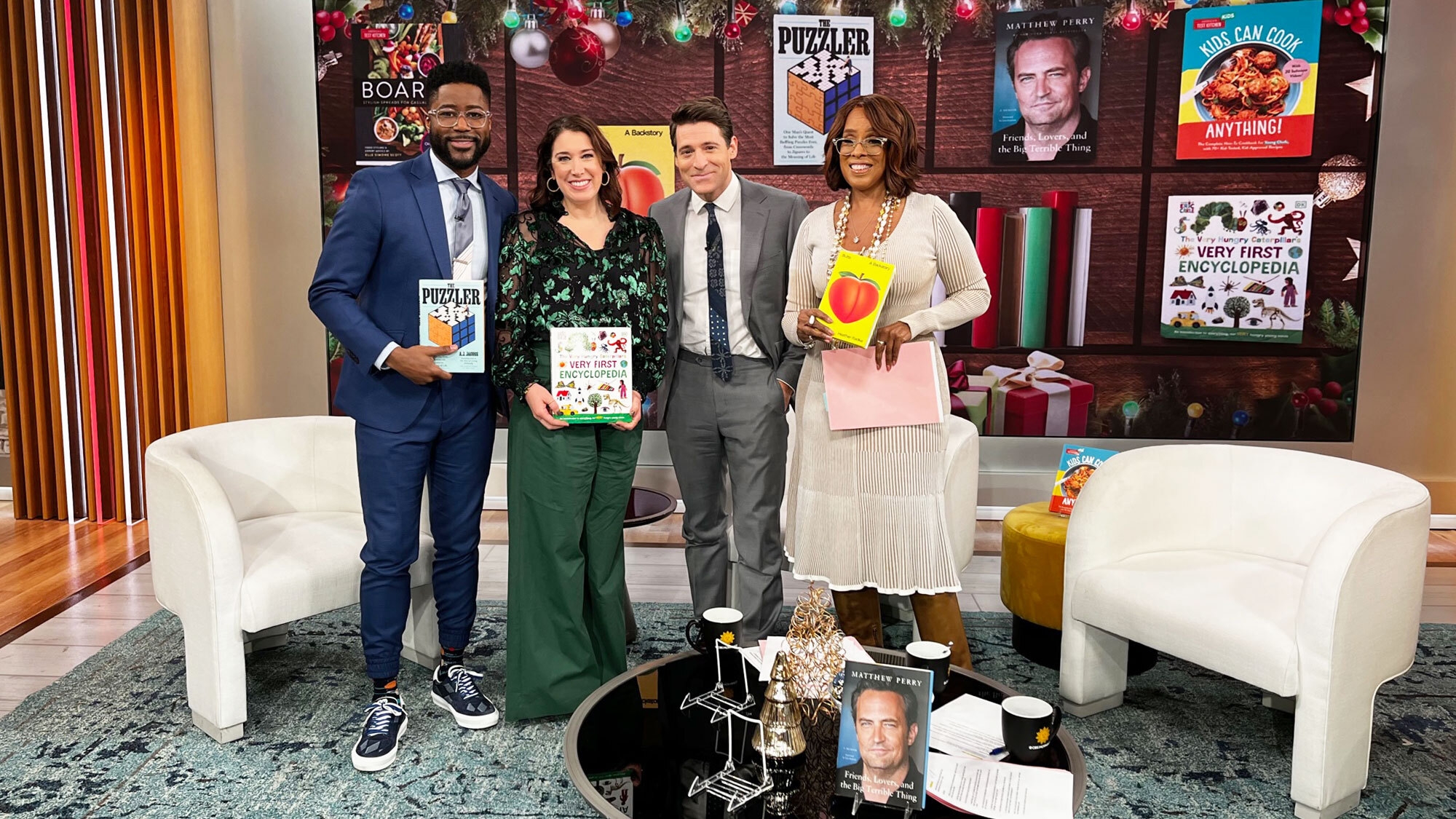 A photo of 'CBS Mornings' show hosts with Amazon Books' editorial director Sarah Gelman on set, holding some of the books featured on a special list of books that are perfect for last-minute gift giving.