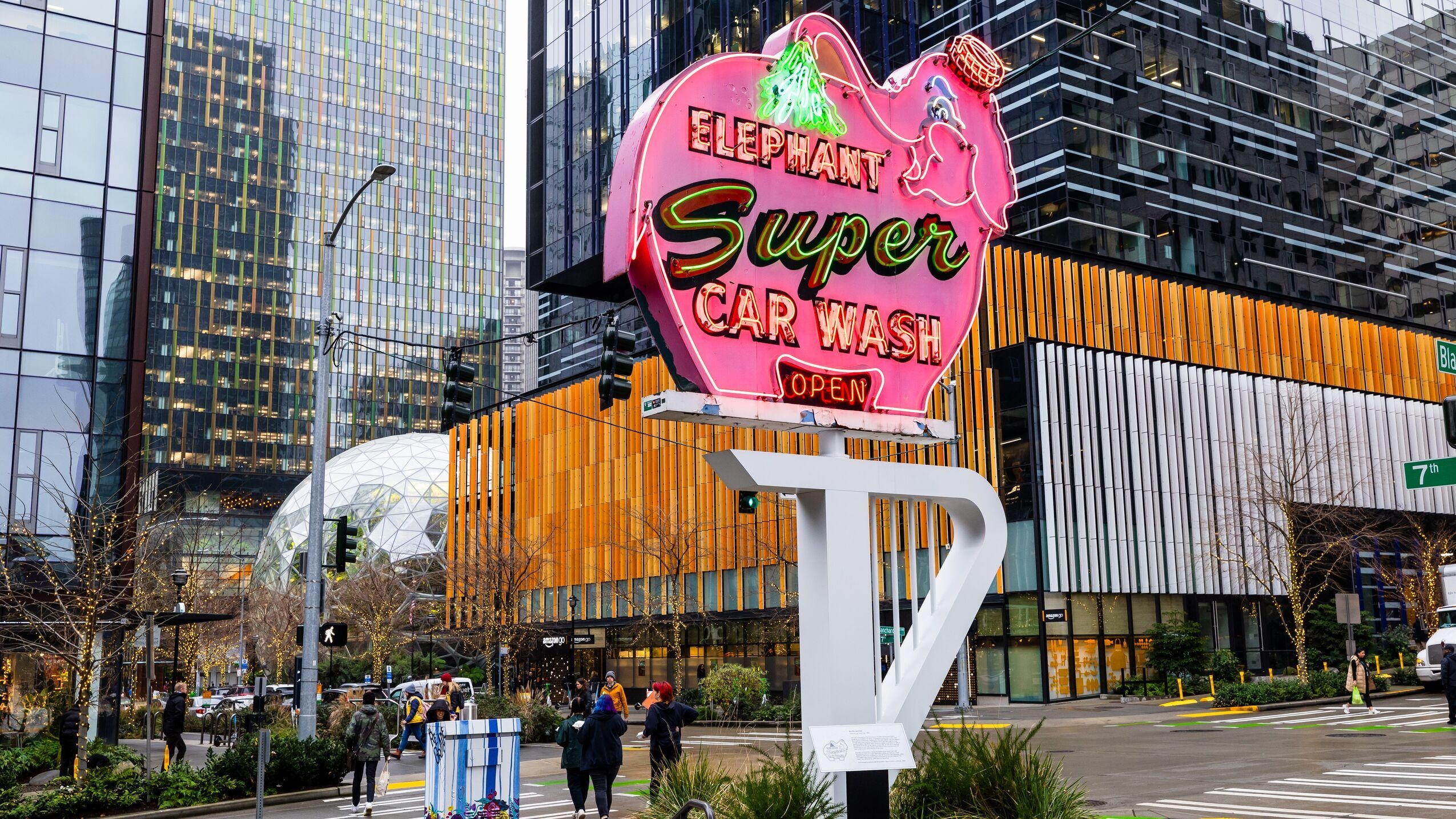 A photo of the Pink Elephant Car Wash sign displayed in front of the Amazon office on 7th Avenue and Blanchard Street in Seattle.