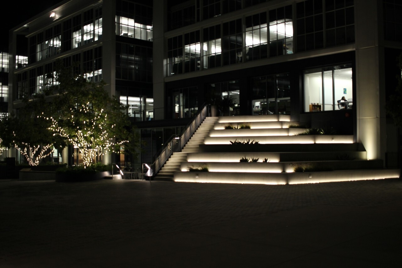 An image of the outside of the Amazon Studios offices at night. Lights illuminate the steps and pathways.