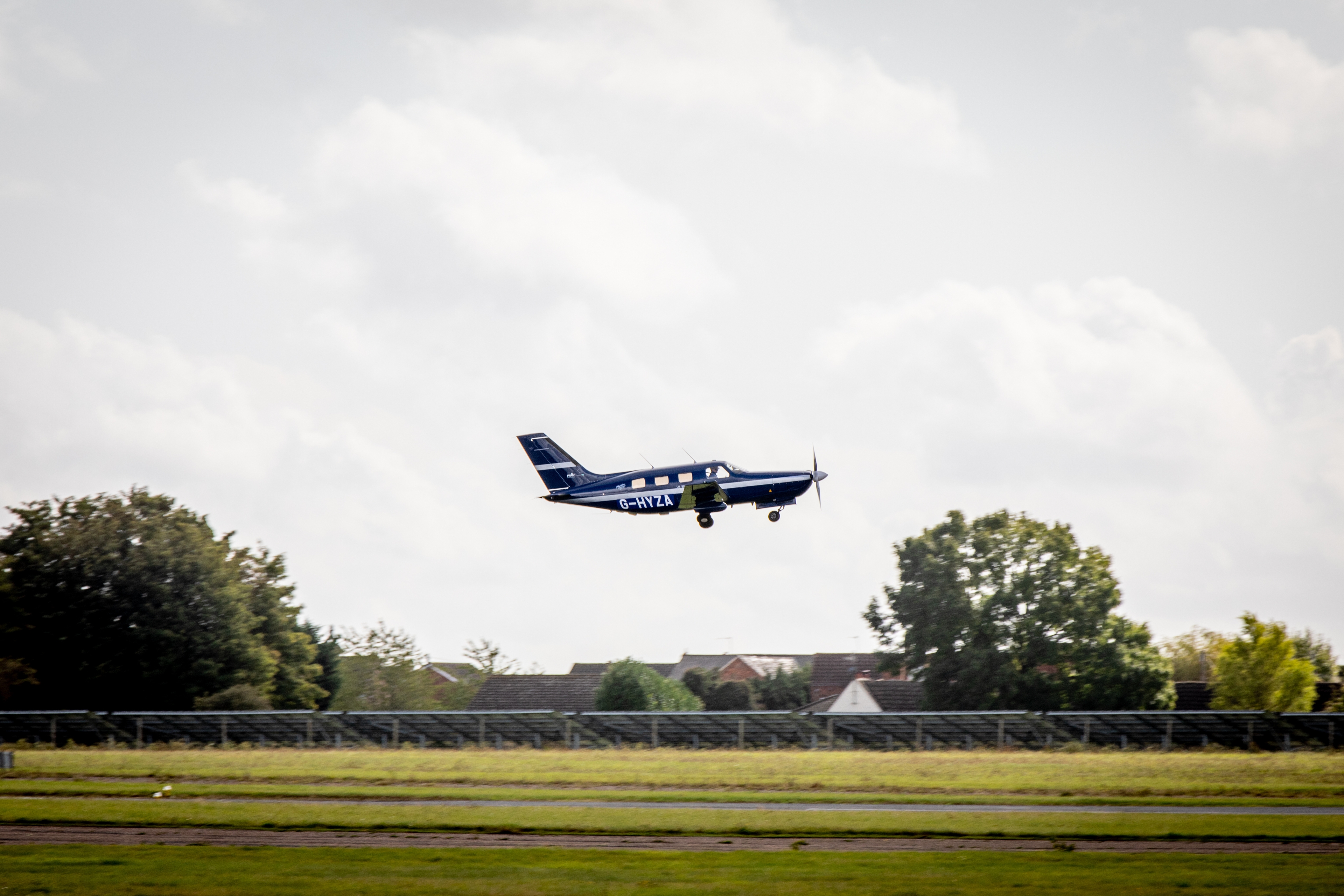 A small plane taking off or landing on a small airfield. 