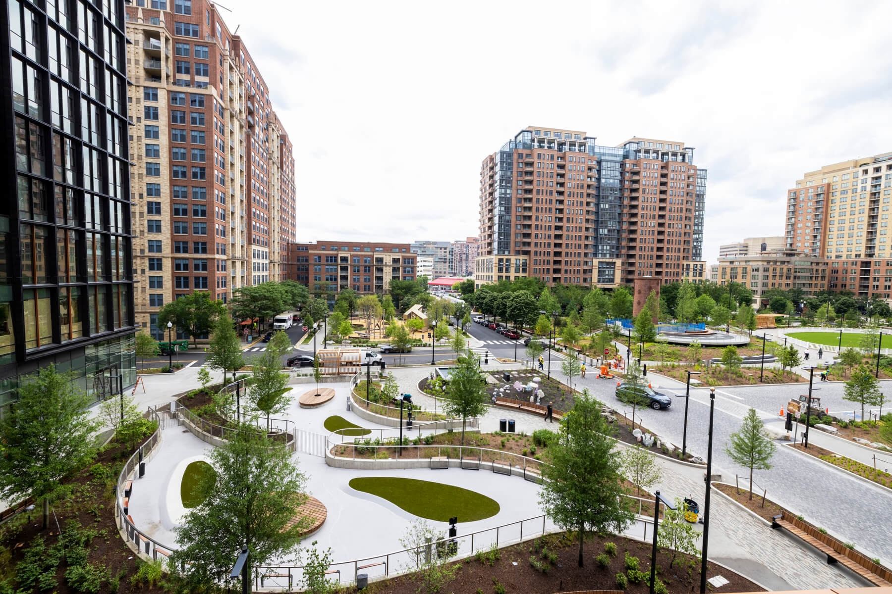 An image of the outside of Amazon HQ2. You can see greenery and several sidewalks that are curved
