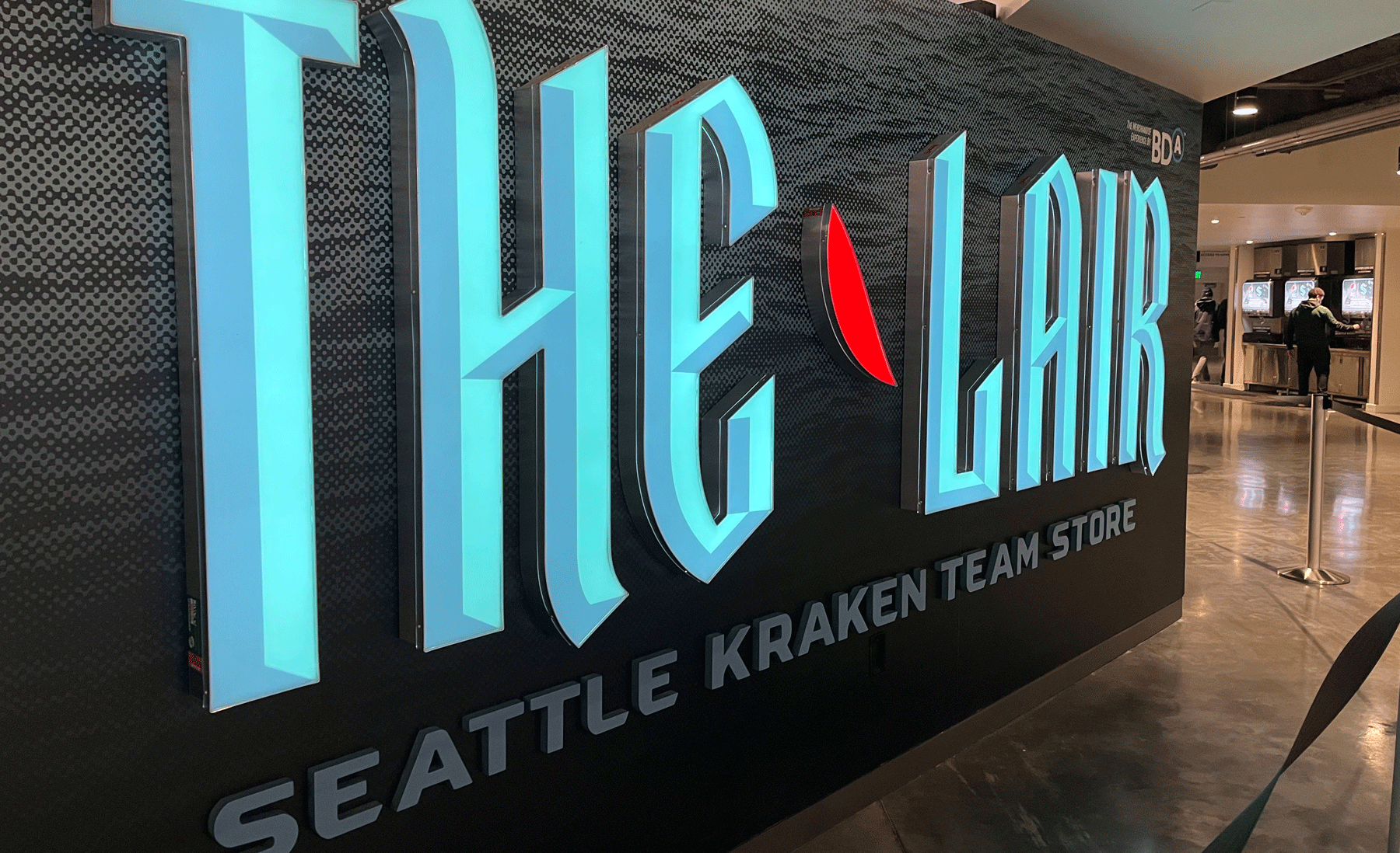 A sign that reads "The Lair, Seattle Kraken Team Store" at the Climate Pledge Arena in Seattle.