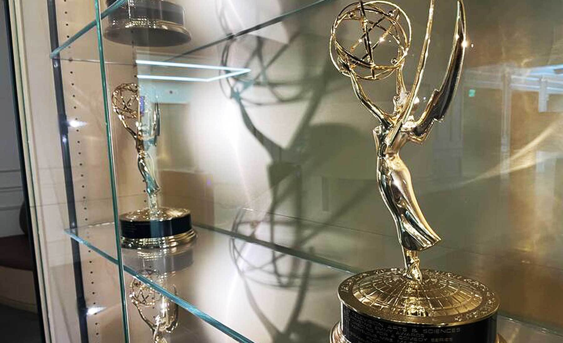 An image of several Emmy awards in a case