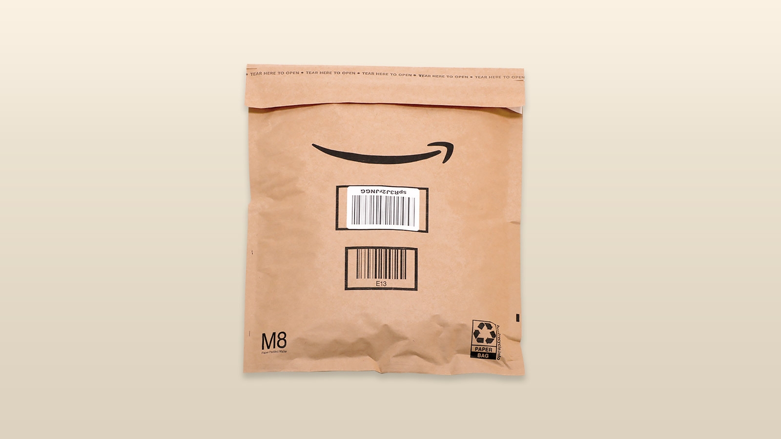 An image of an amazon package with a beige background.