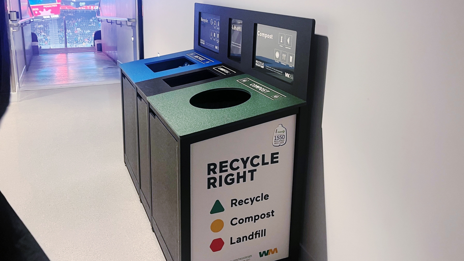 An image of the recycling, trash, and compost bin at Climate Pledge Arena. There are labels and color coding to show what goes where.