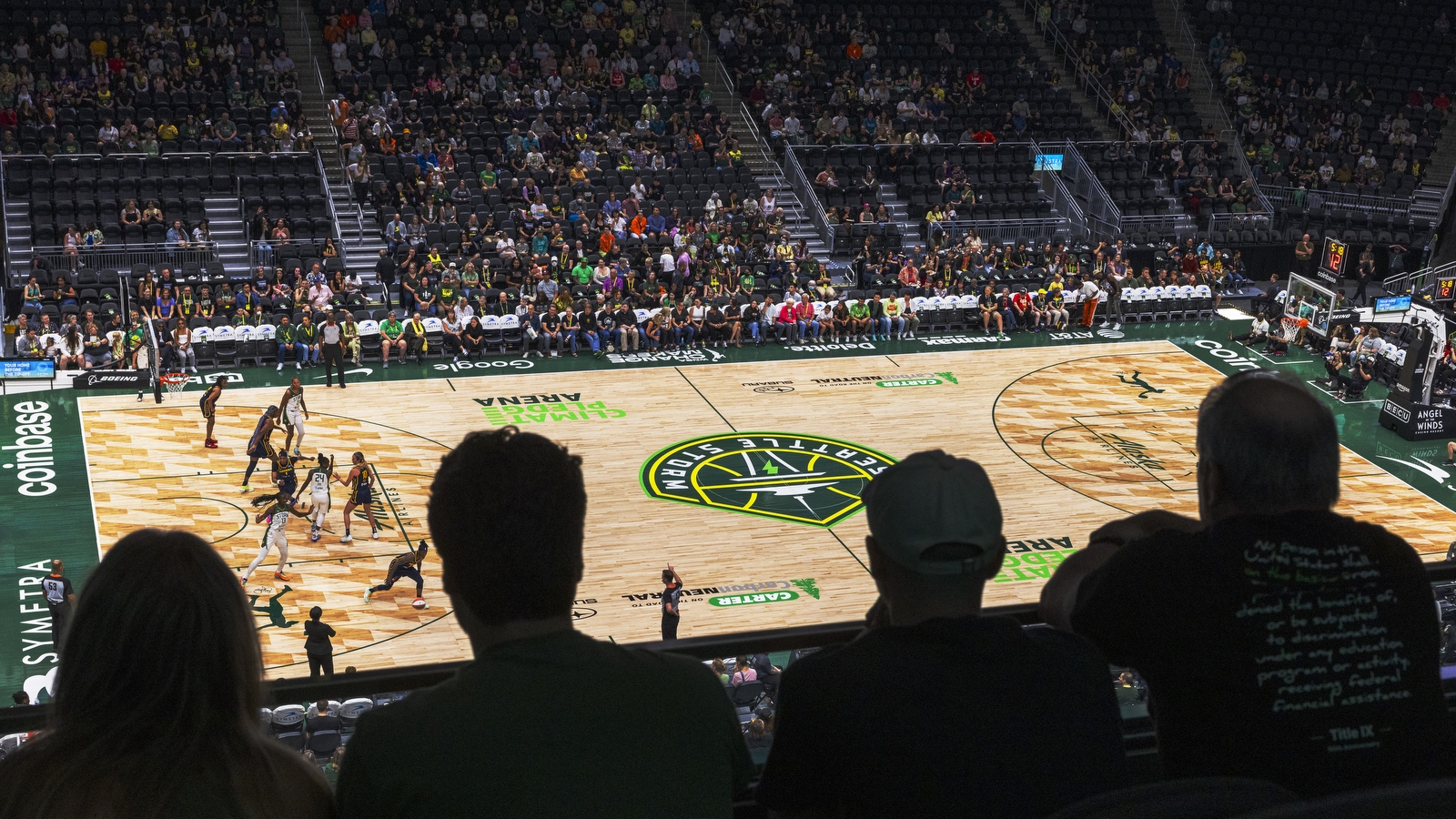 An image of the Seattle Storm basketball court at Climate Pledge Arena. The view is from a seat toward the upper bowl of the arena.