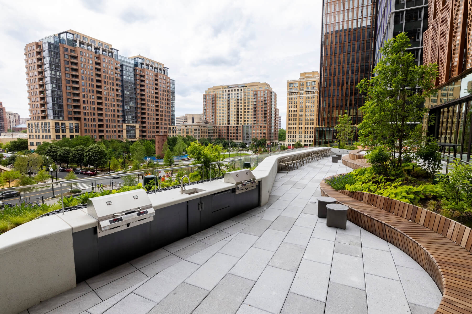 An image of a grill and several wooden seating areas on the terrace at Amazon's HQ2